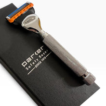 Load image into Gallery viewer, A Parker safety razor with a textured silver handle and orange and blue protective guard, resting on a black branded fabric pouch against a white background.