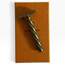 Load image into Gallery viewer, A vintage-style safety razor with a twisted handle in antique bronze and black, resting diagonally on top of its textured orange-brown presentation box. The box features the brand name 'parker' and 'Safety Razor' printed in black.
